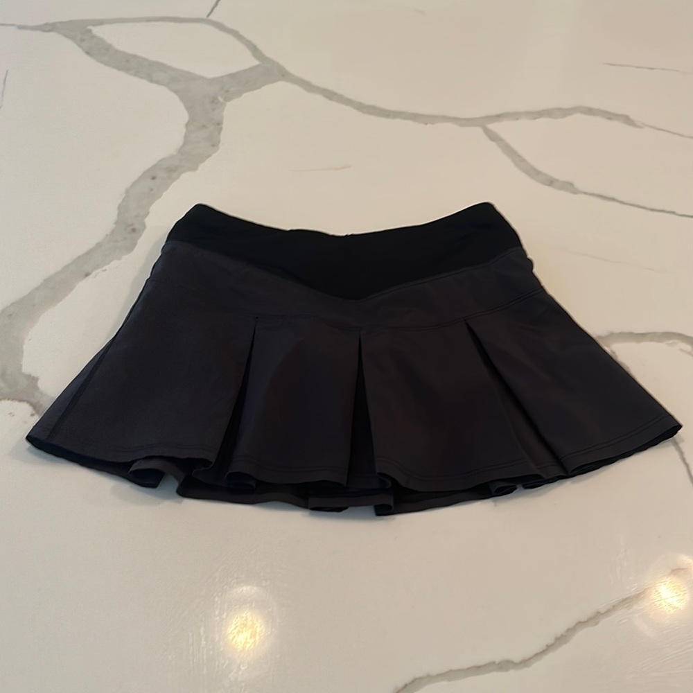 Black Ivivva tennis skirt. Size: girls 8. Shorts underneath!